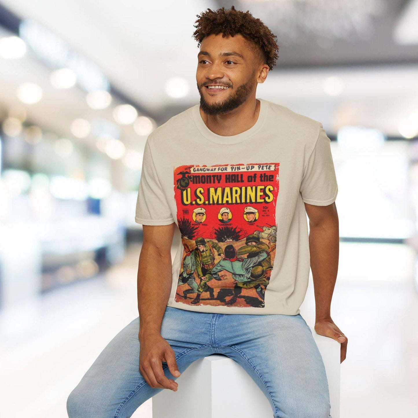 Man wearing a t-shirt with a graphic design of U.S. Marines in an indoor setting