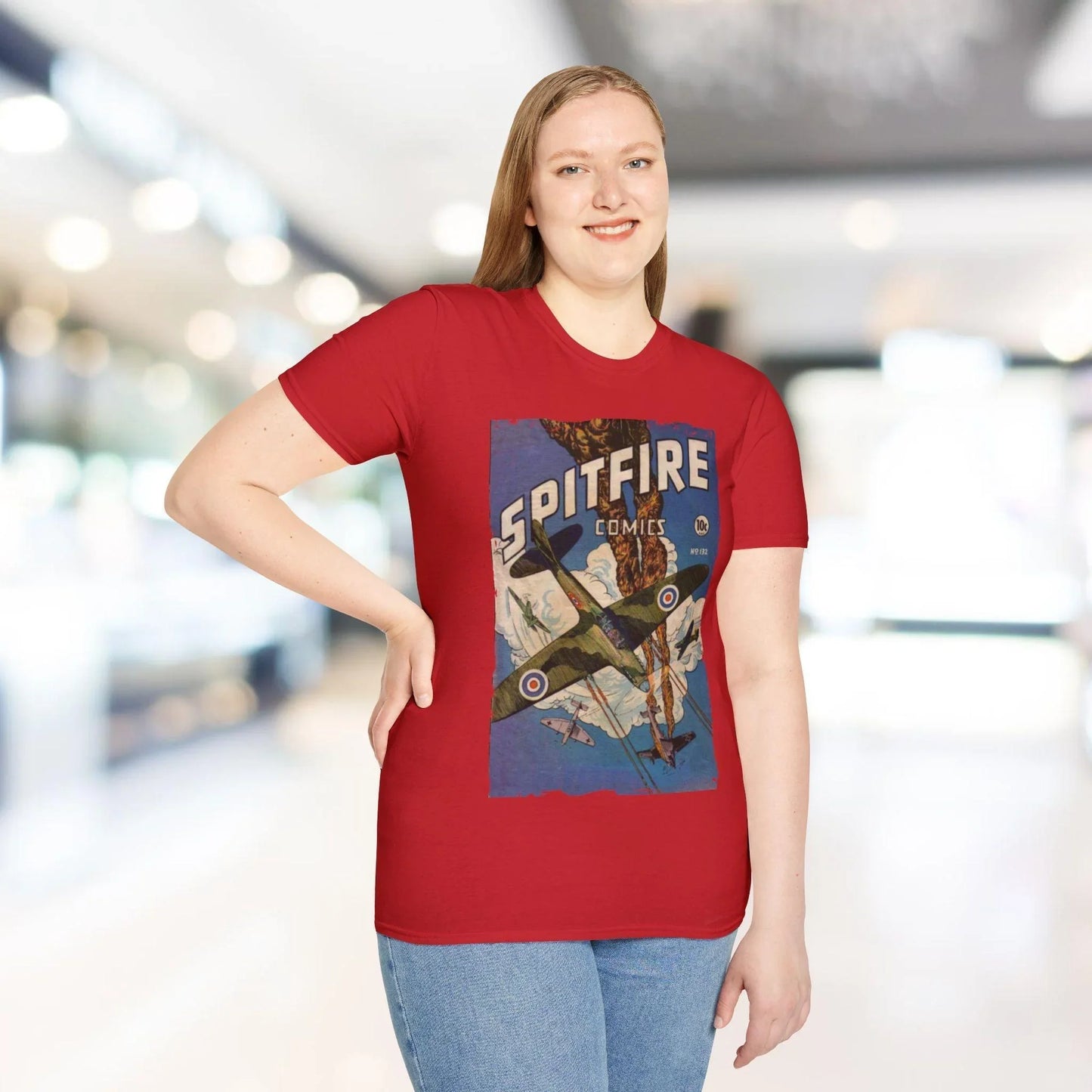 Person wearing a red t-shirt with a Spitfire graphic design in an indoor setting