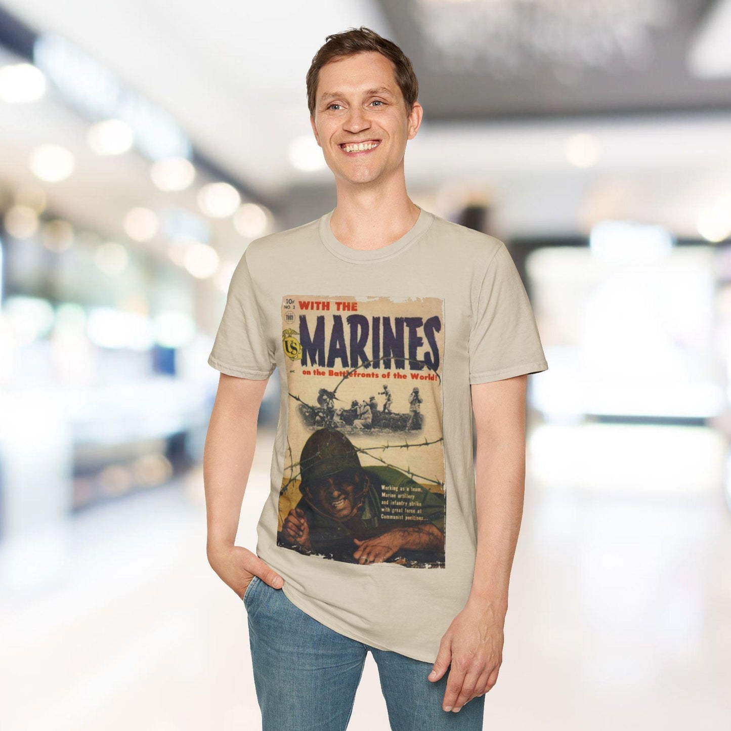 Person wearing a t-shirt with a graphic design and text, standing in an indoor setting.