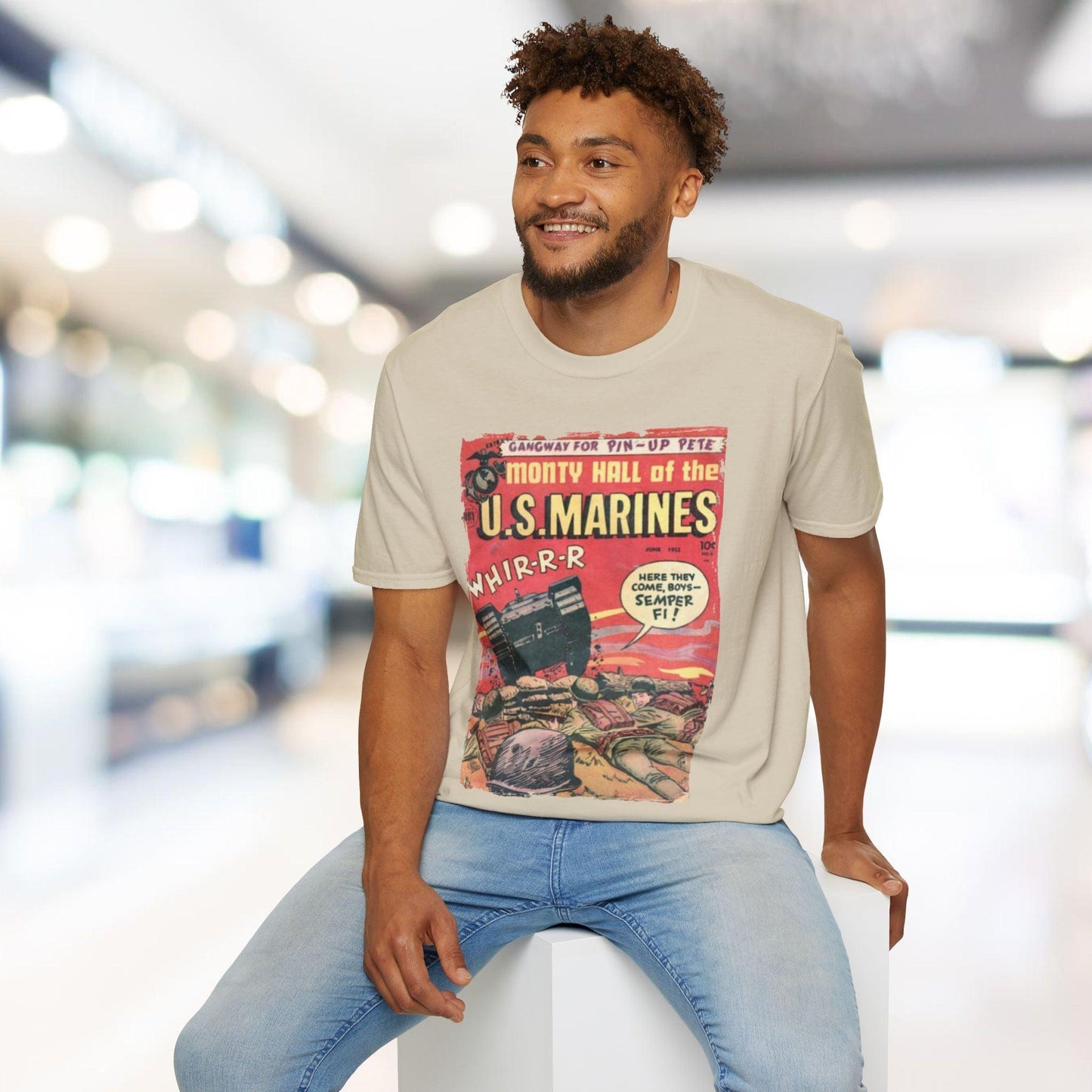 Man wearing a t-shirt with a graphic design of U.S. Marines and sitting on a stool.
