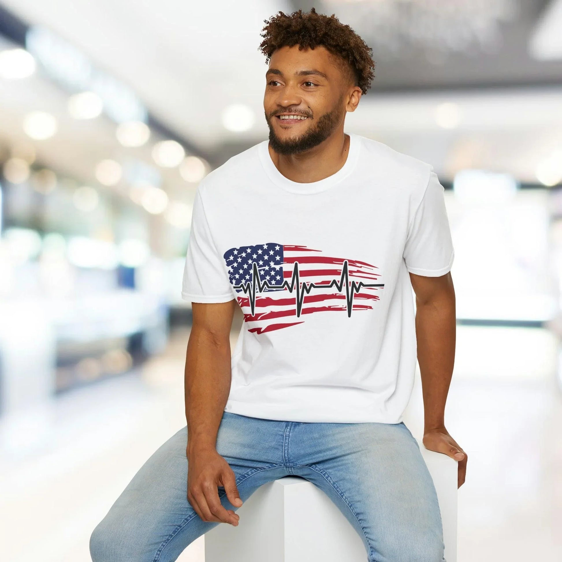 Close-up of the distressed flag heartbeat graphic on the front chest area of the unisex softstyle T-shirt, highlighting the