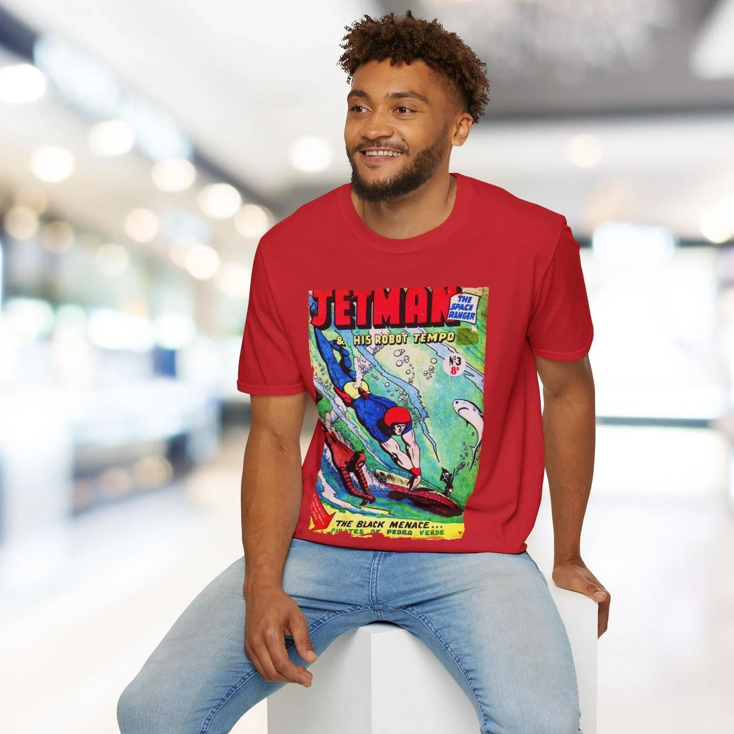 Close-up of the Jetman No.3 T-shirt label stitched on soft cotton fabric, showing size and care instructions at the hem seam.