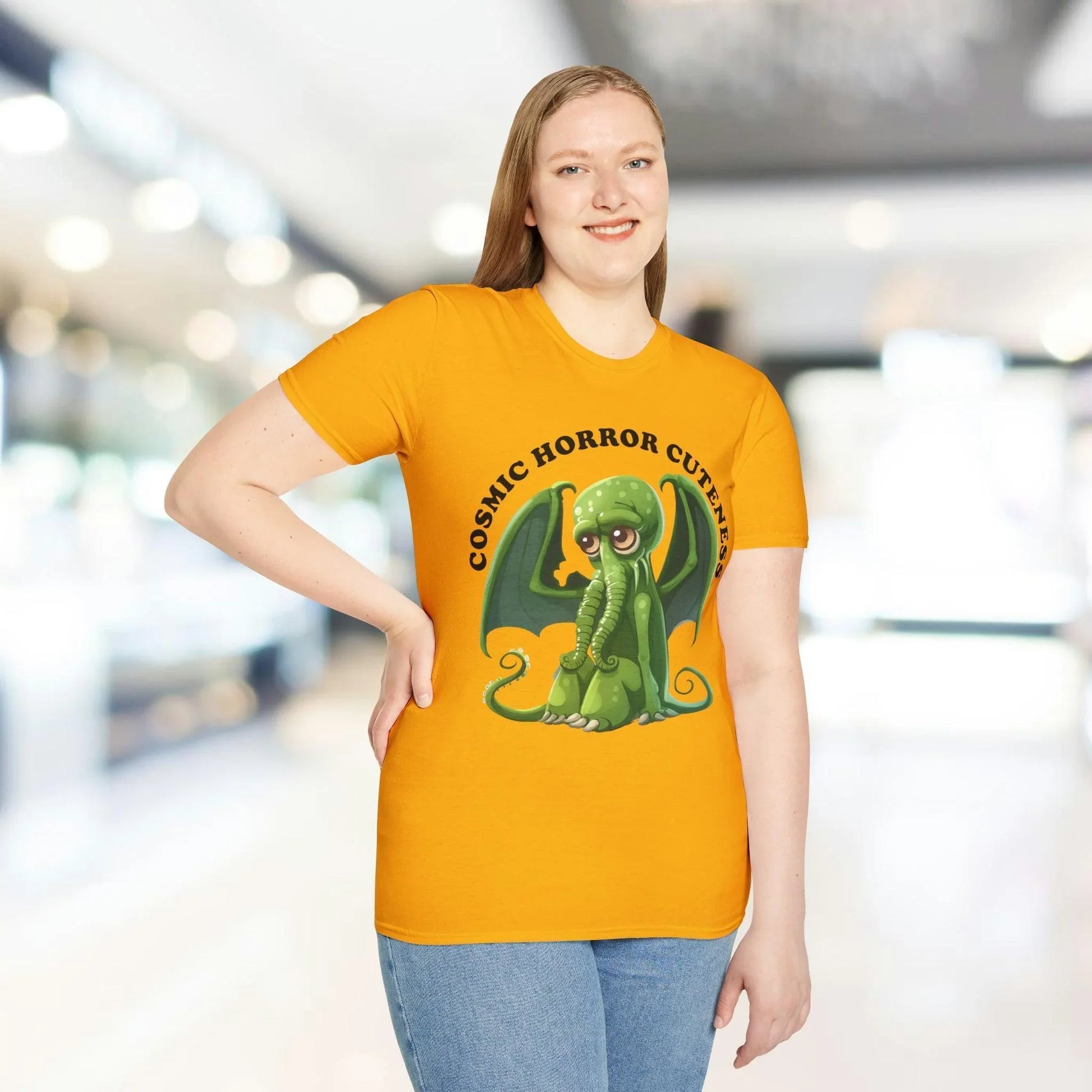 Close-up of the cosmic horror and cute alien design on the front chest area of the unisex softstyle T-shirt in midnight