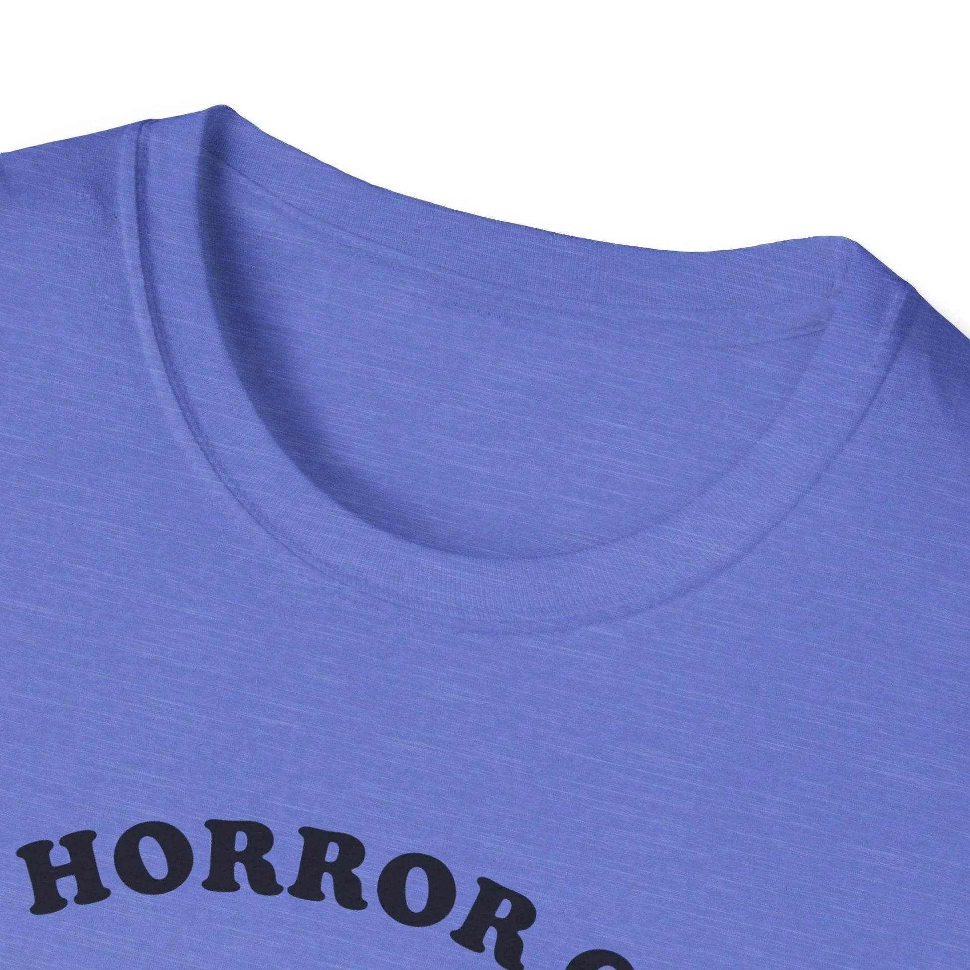 Close-up of the Cosmic Horror Cuteness T-Shirt neck tag showing fabric blend and unisex fit in deep purple color