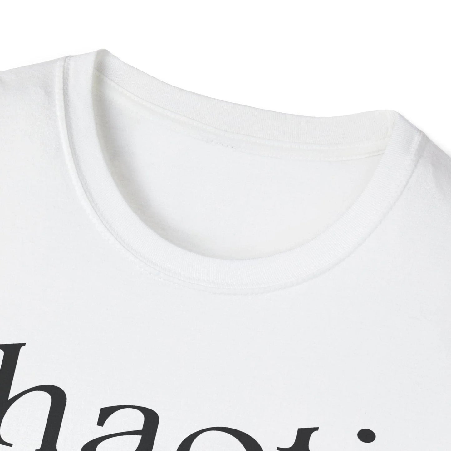 Close-up of the black cotton fabric's smooth texture and subtle stitching along the relaxed fit neckline from a low-angle