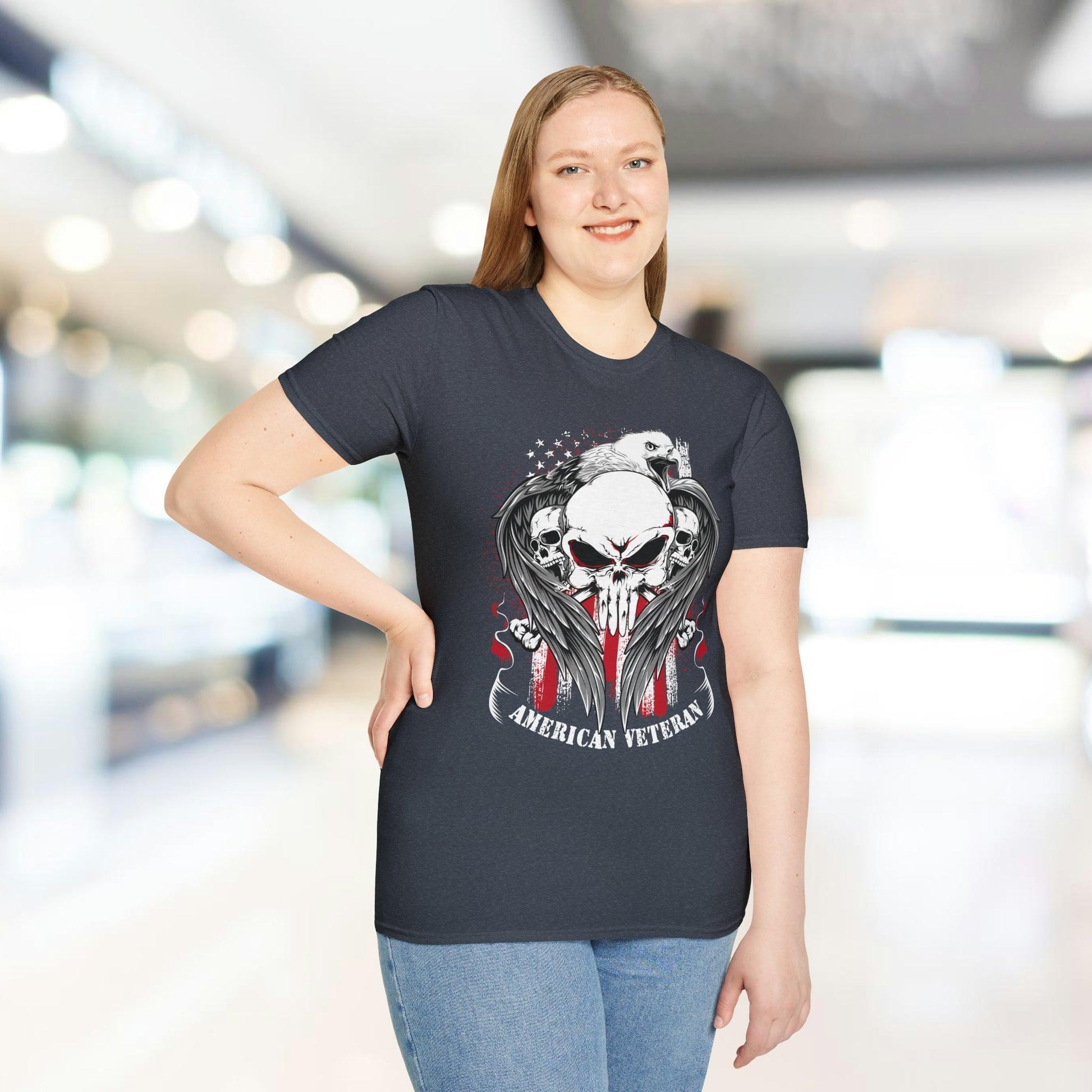 Close-up of the American Veteran unisex softstyle T-shirt’s white neckline tag displaying size and care instructions from a