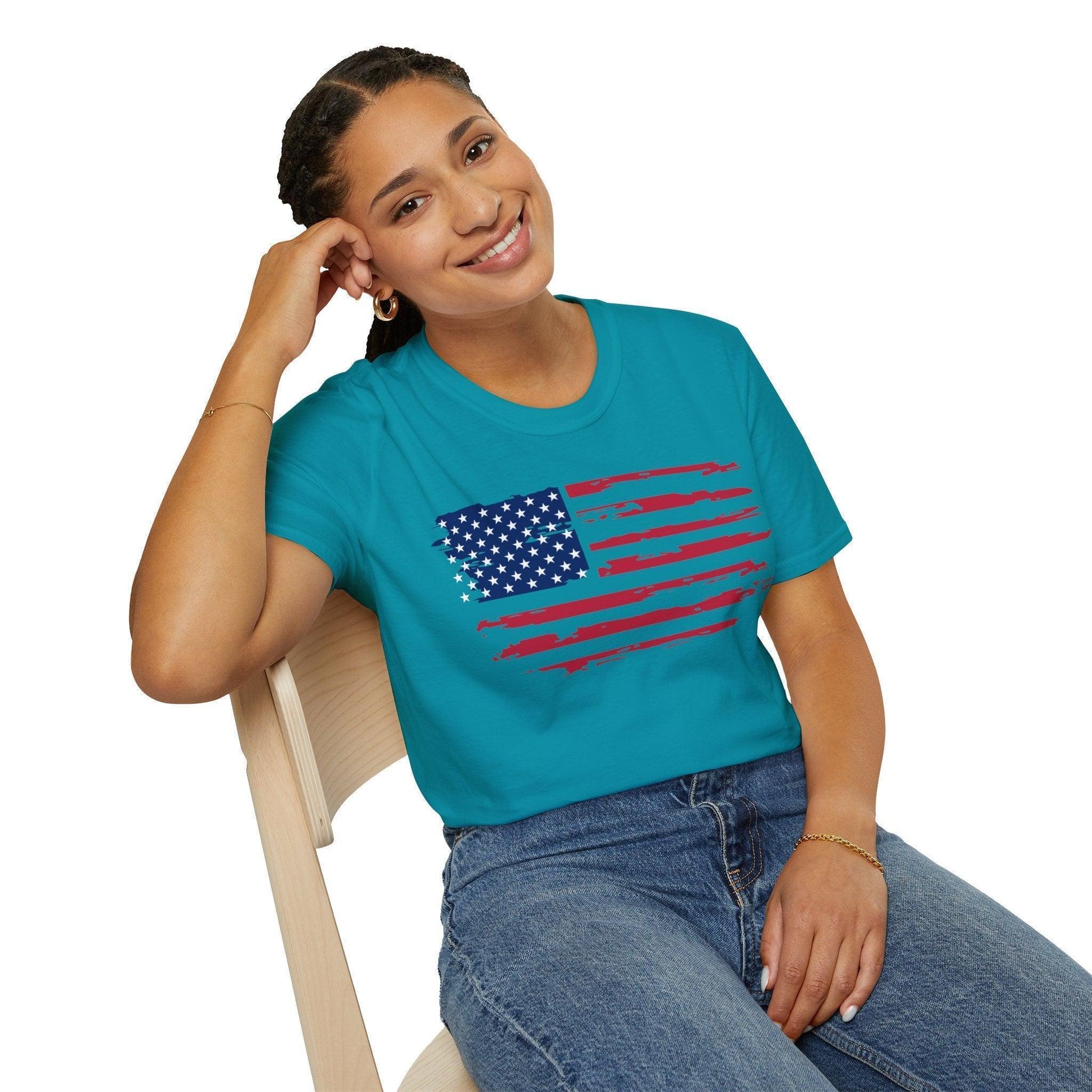 Close-up of the distressed American flag print on the relaxed fit, soft cotton fabric showing vibrant red, white, and blue