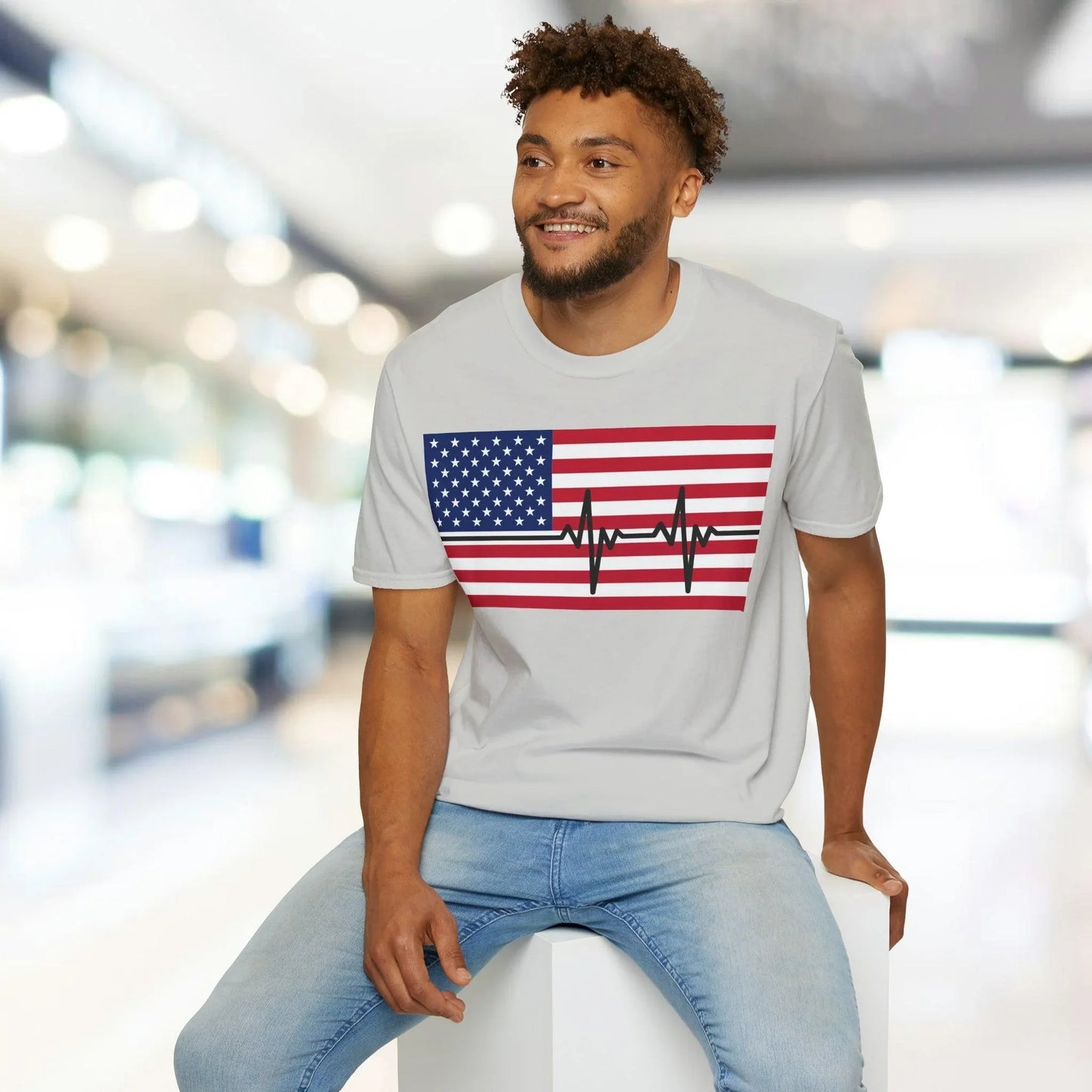 Close-up of the unisex softstyle fabric showing vibrant American flag heartbeat print, highlighting smooth texture and