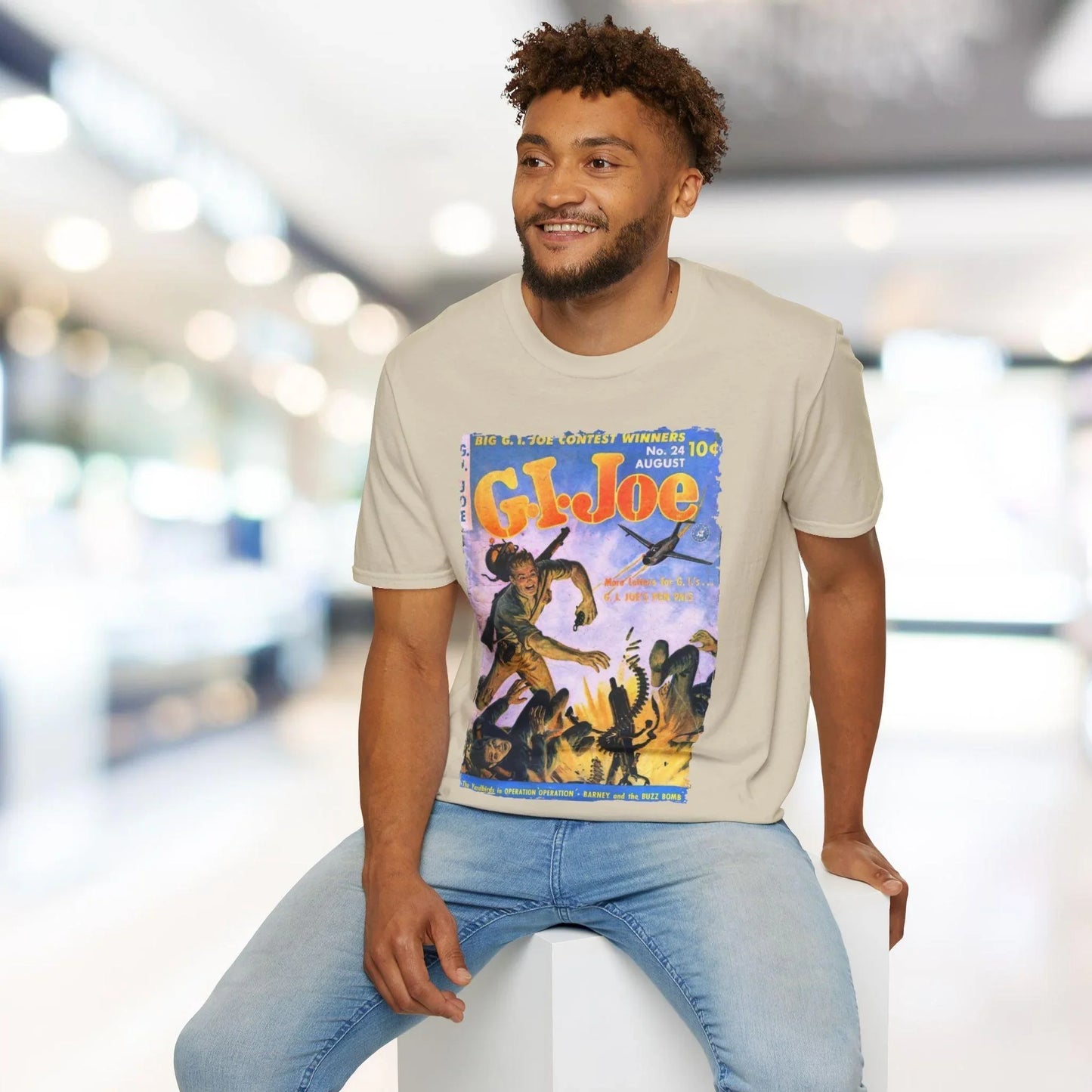 Close-up of the G.I. Joe No.24 softstyle T-shirt's neck label and subtle heather gray fabric texture from an overhead angle.