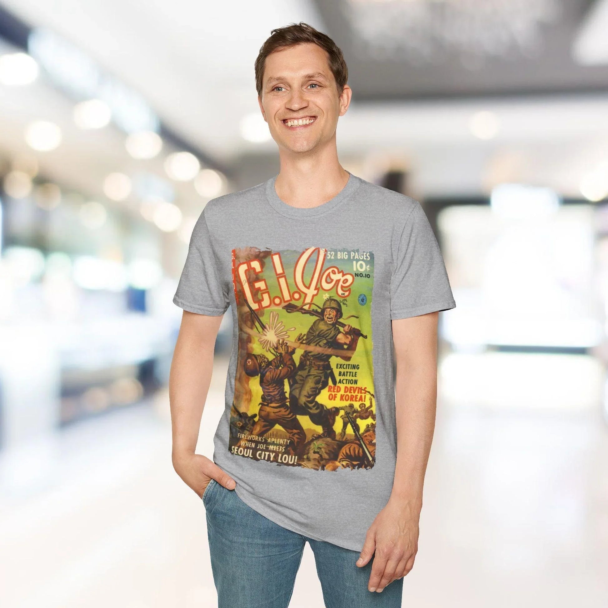 Close-up of the G.I. Joe No.10 unisex softstyle t-shirt’s label sewn onto the light gray fabric showing size and material