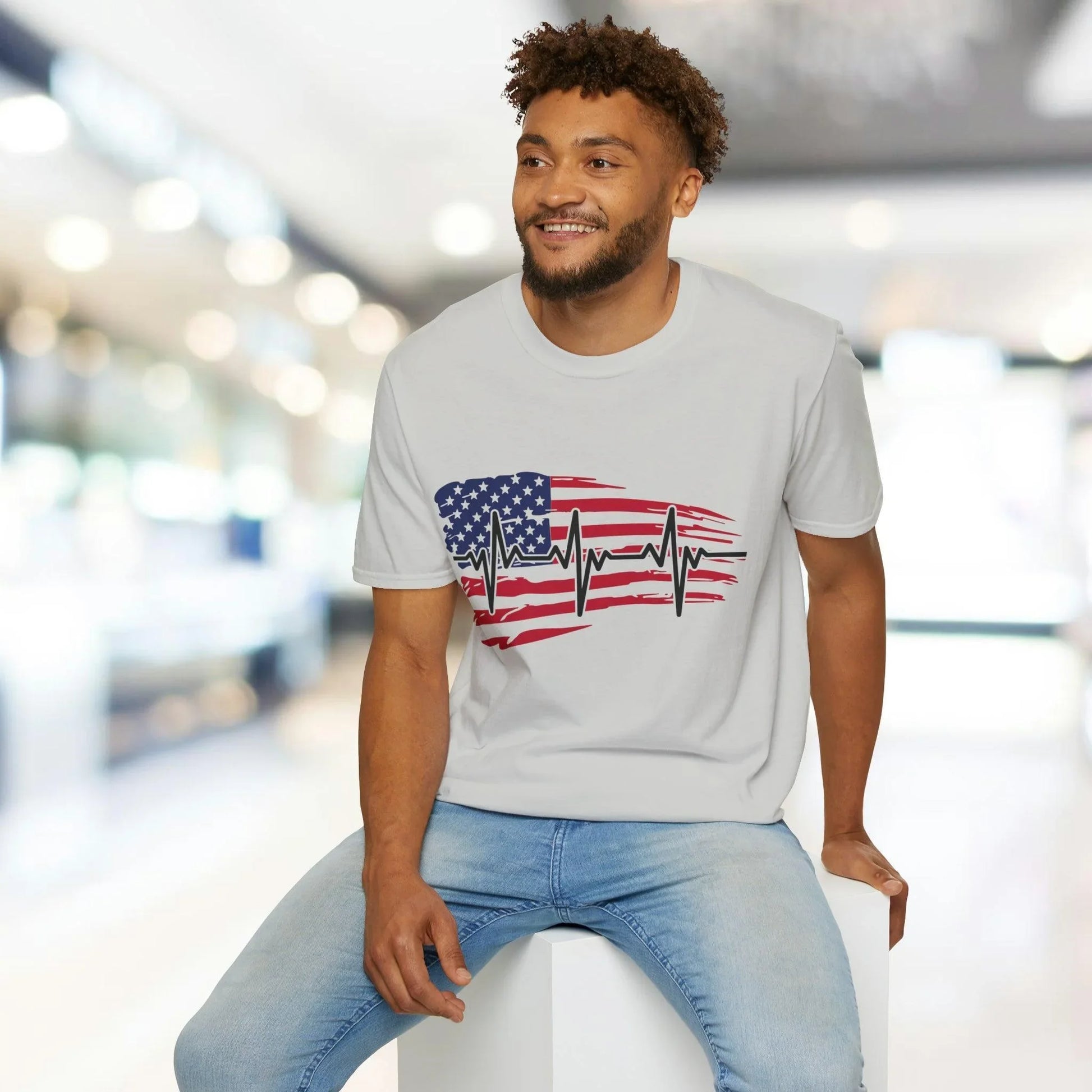 Close-up of the distressed flag heartbeat graphic showcasing vivid red, white, and blue colors on the soft cotton fabric of