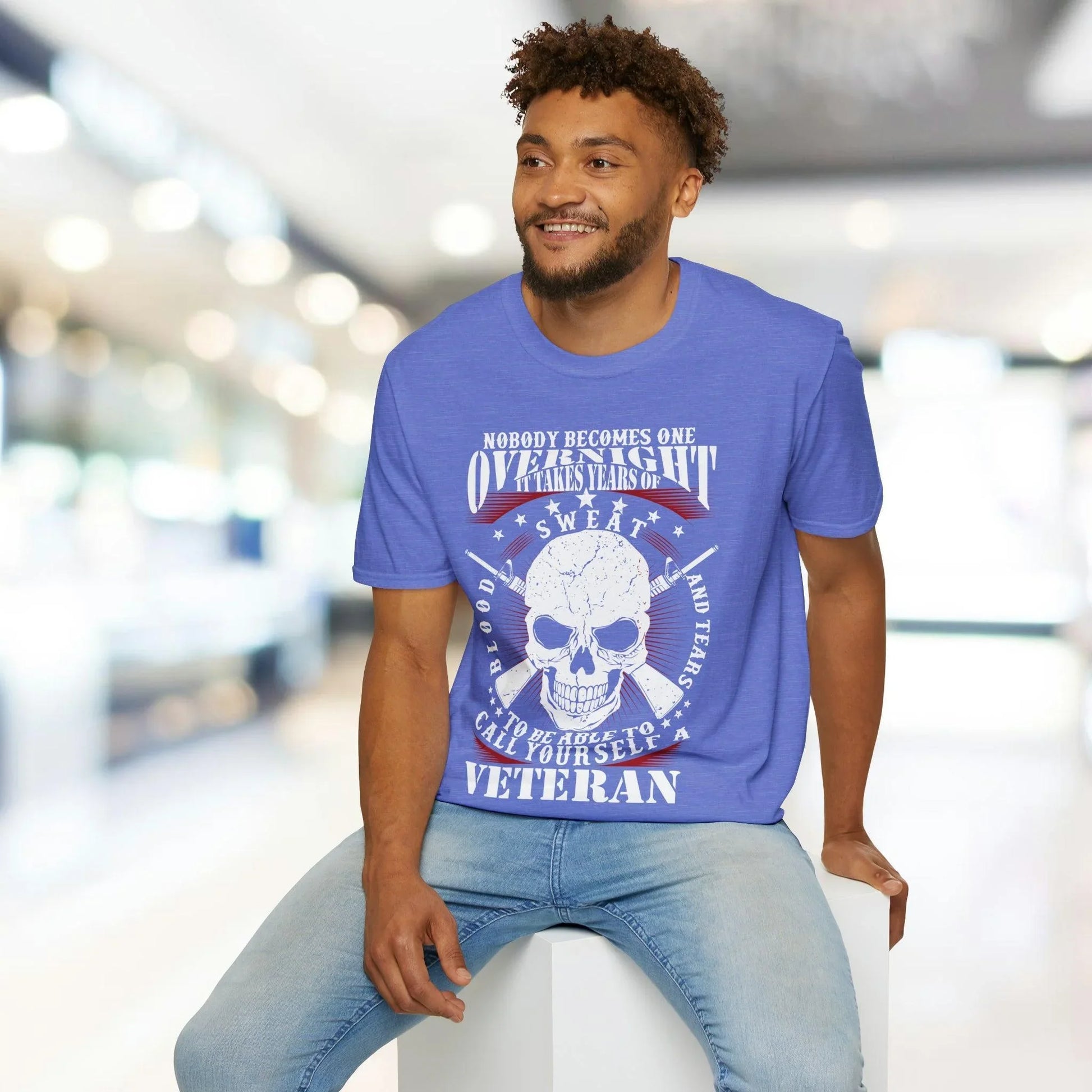 Close-up of the unisex softstyle T-shirt's relaxed fit label sewn inside the collar in black text on white fabric.