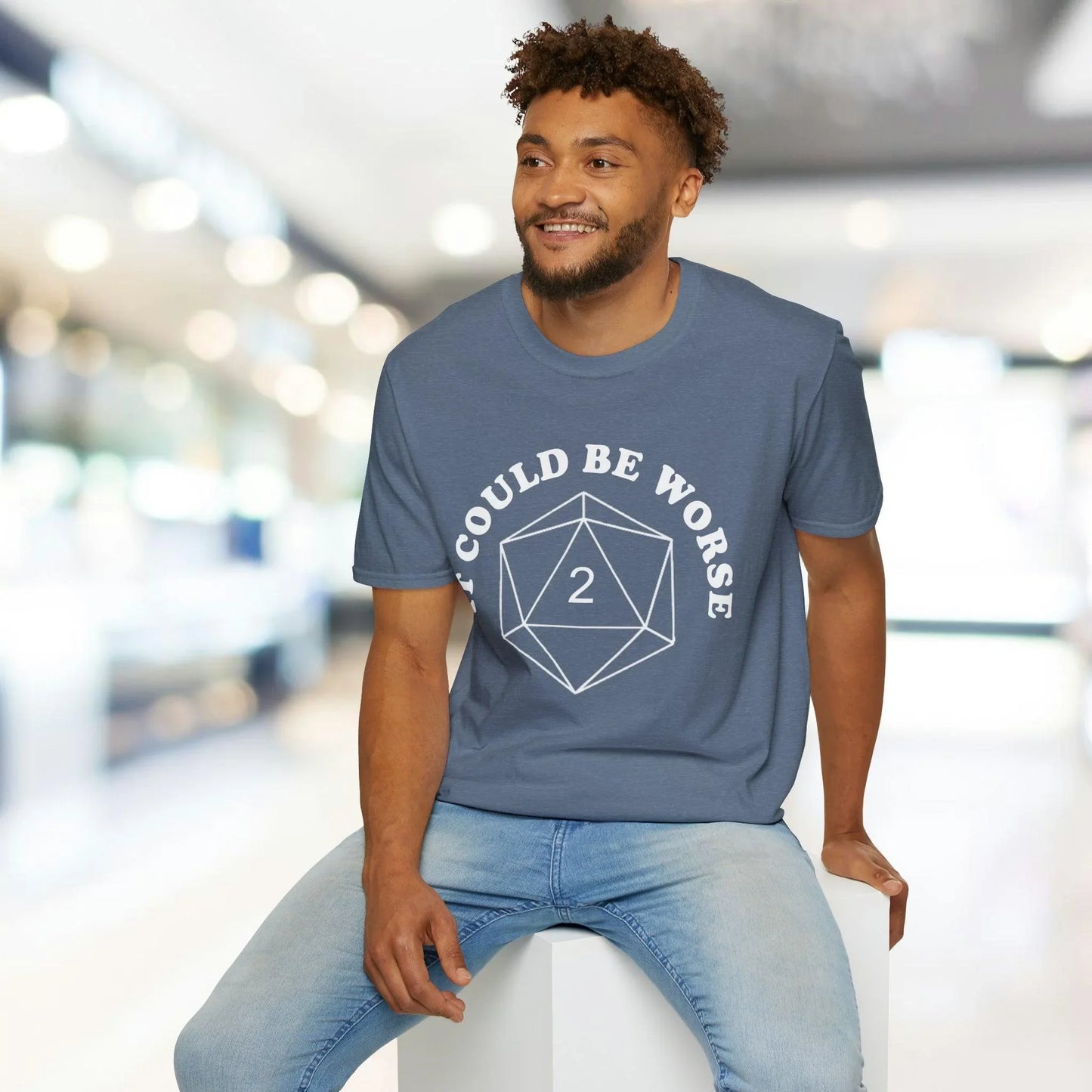 Close-up of the white unisex softstyle T-shirt's fabric texture and subtle stitching detail at the sleeve seam from a front