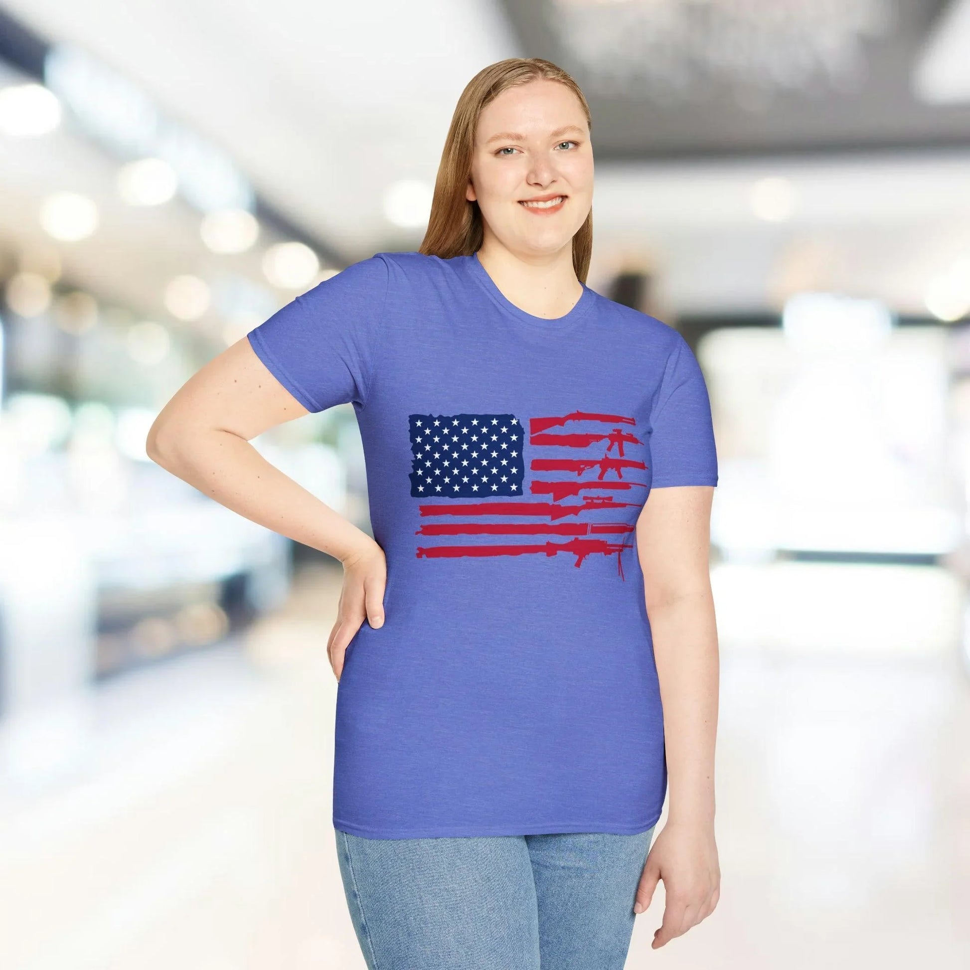 Close-up of the American flag guns graphic on the chest of the soft blue cotton T-shirt, highlighting vibrant print details