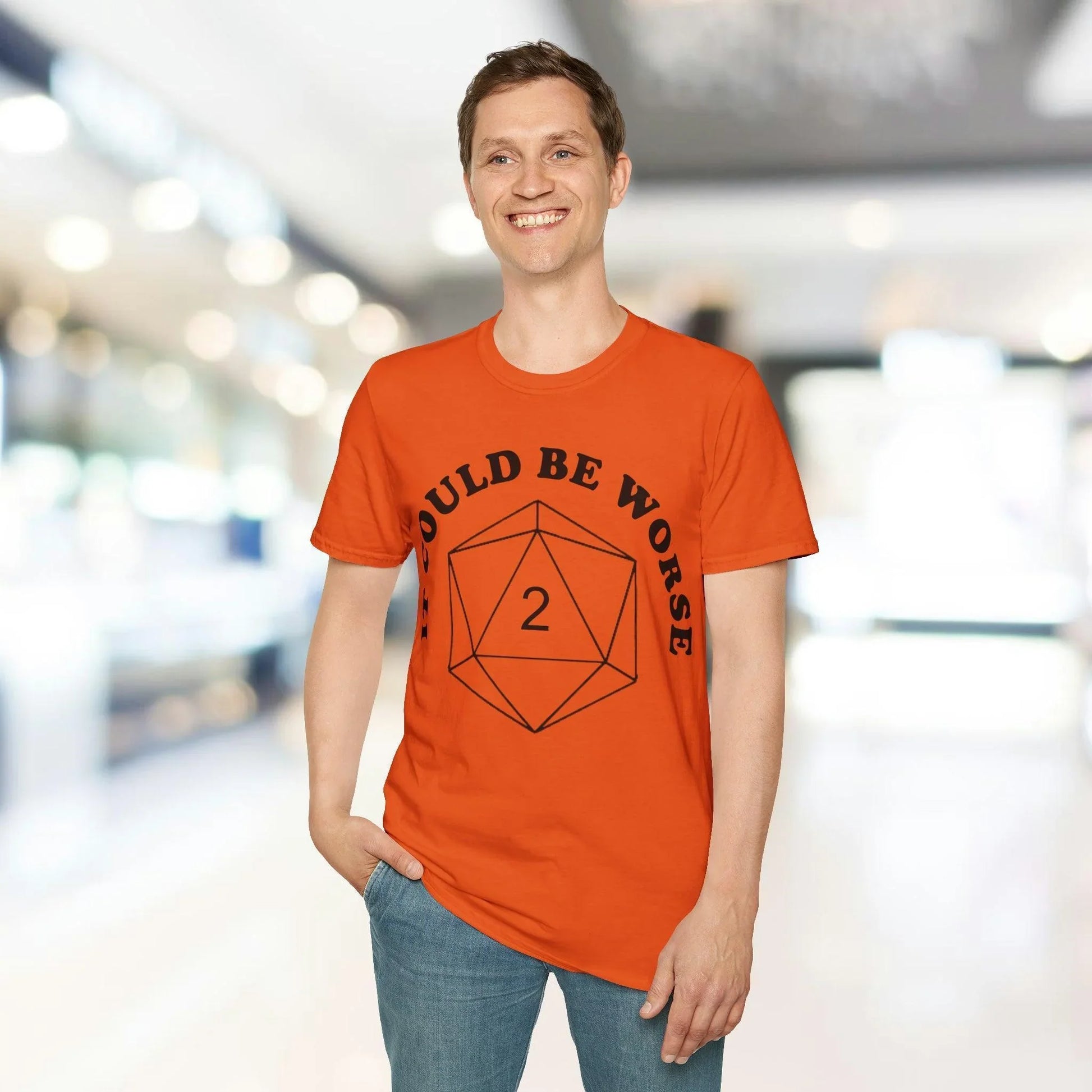 Close-up of black unisex softstyle T-shirt fabric showing subtle texture and comfortable relaxed fit at the hem seam.