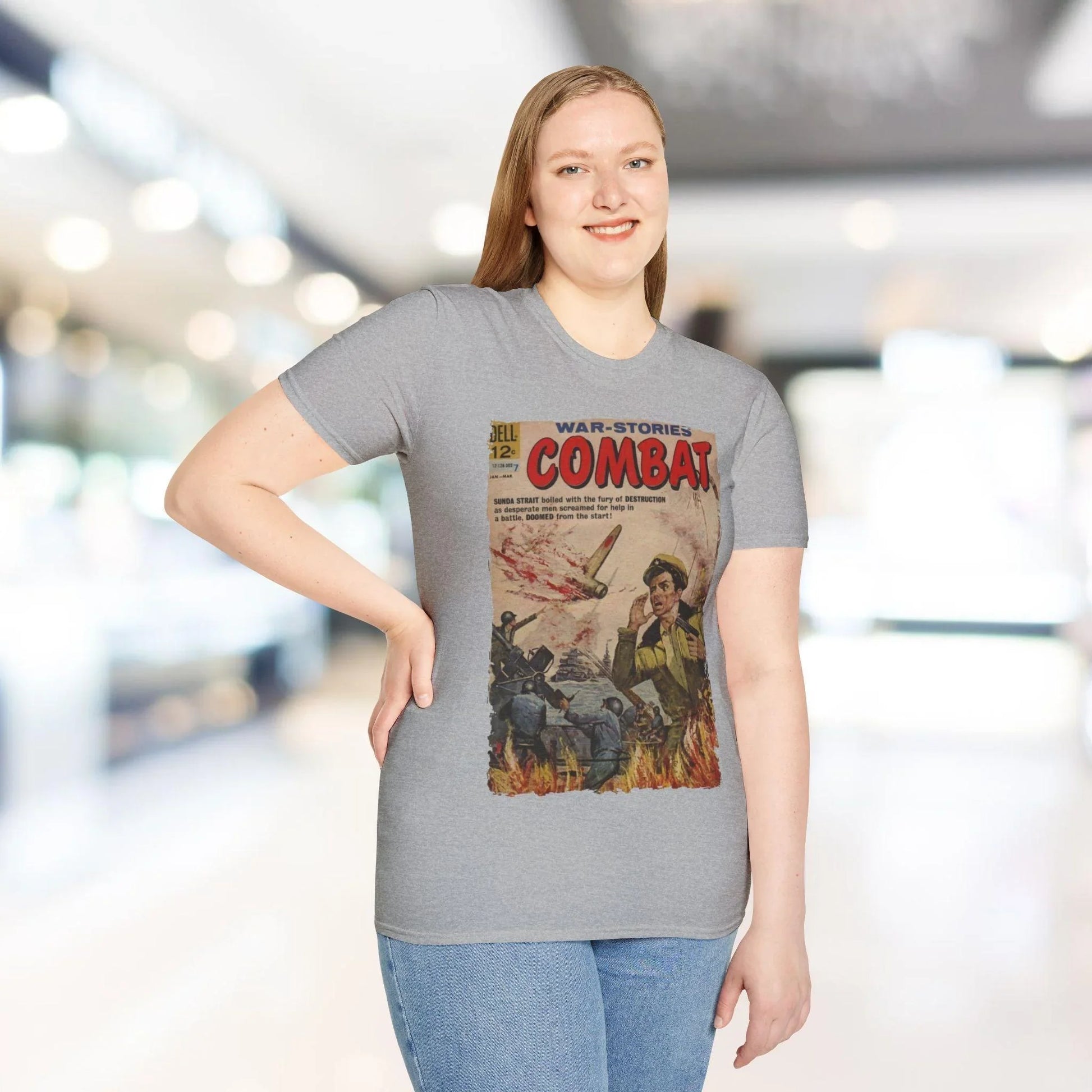 Close-up of the chest logo detail showcasing the smooth, heather gray fabric and ribbed neckline of the unisex softstyle