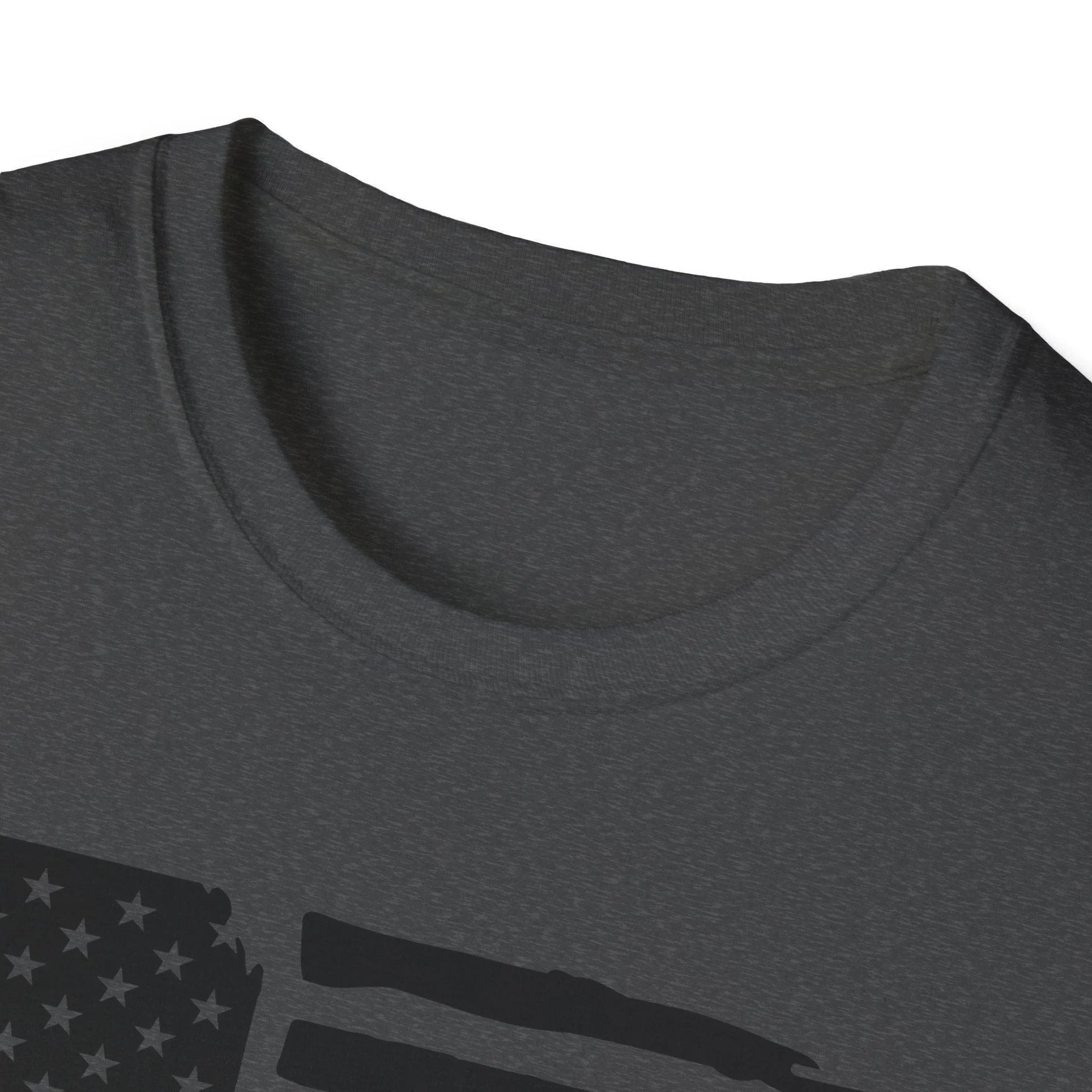 Close-up of distressed black and white American flag graphic on unisex softstyle T-shirt's front neckline area, showcasing