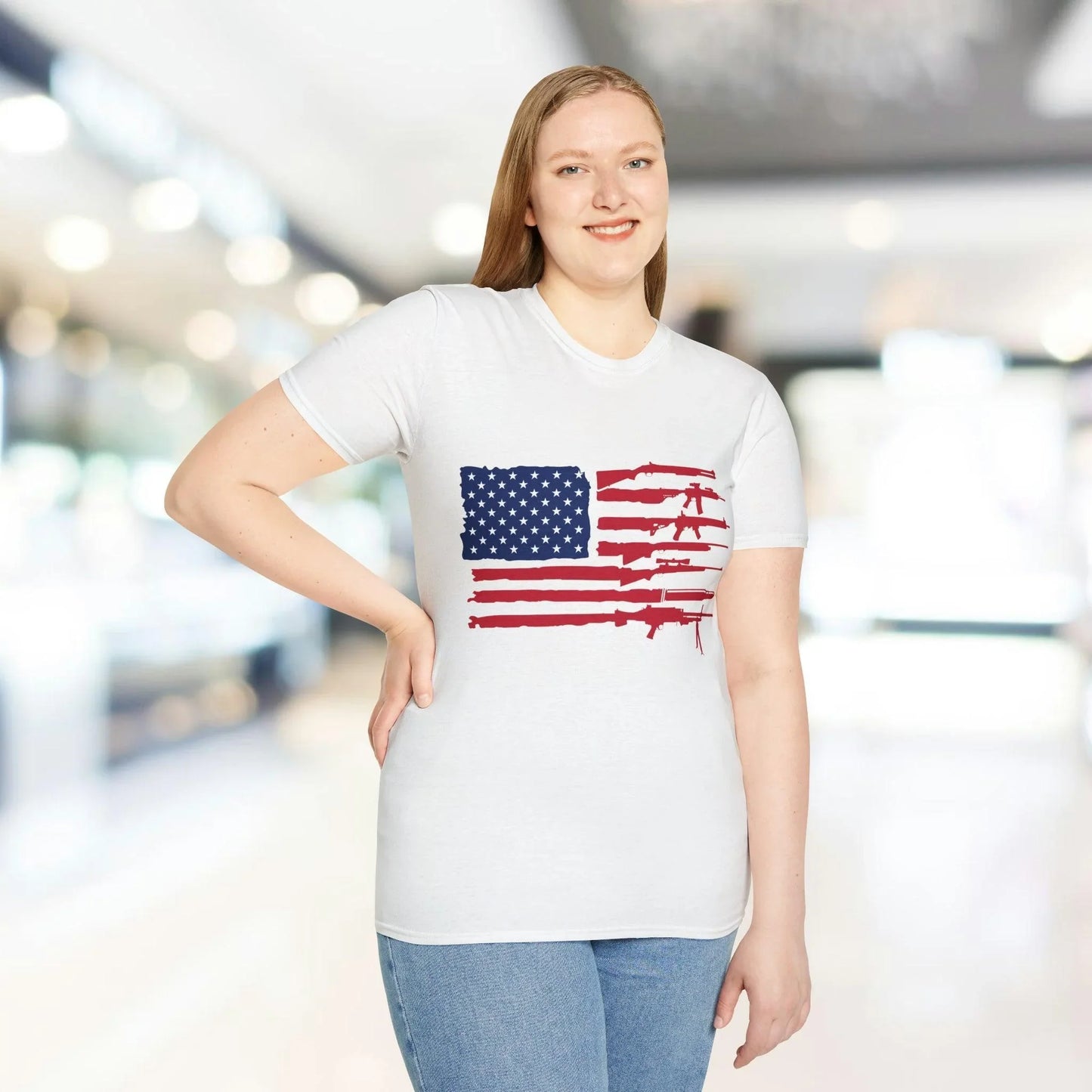 Close-up of the American flag guns print on the unisex softstyle T-shirt's front center, highlighting vibrant colors and