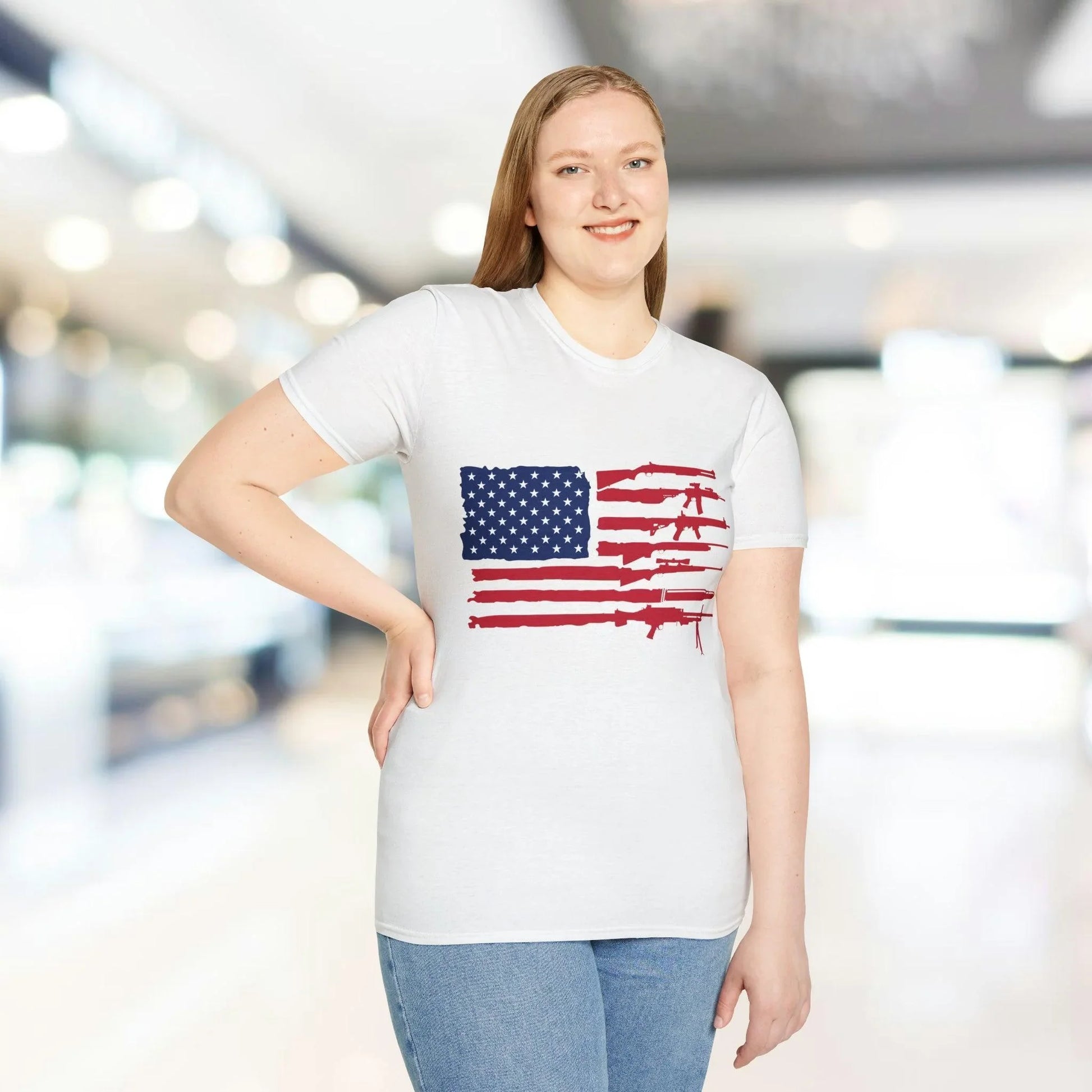 Close-up of the American flag guns print on the unisex softstyle T-shirt's front center, highlighting vibrant colors and