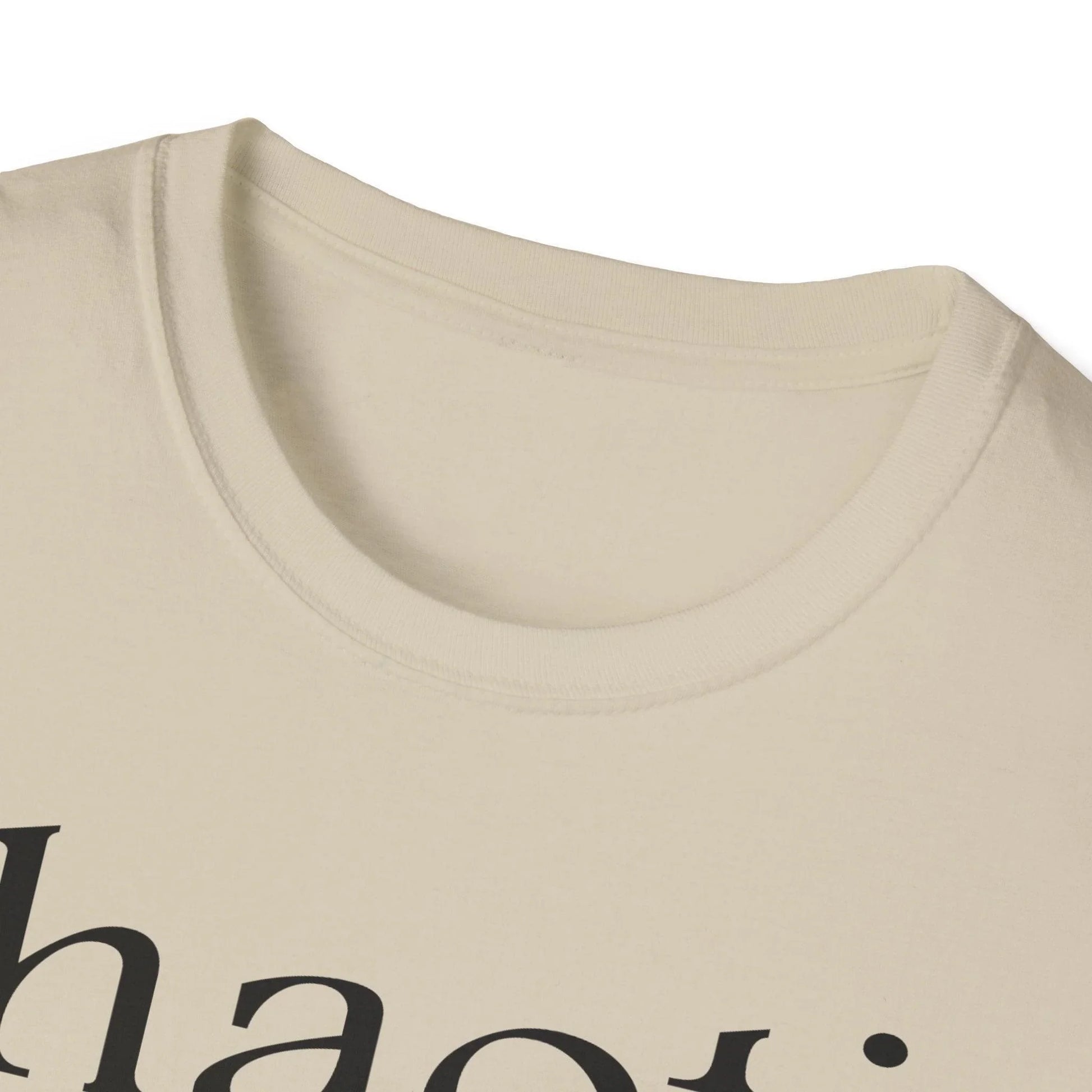 Close-up of the black cotton fabric highlighting the smooth, soft texture and reinforced neckline stitching at the collar