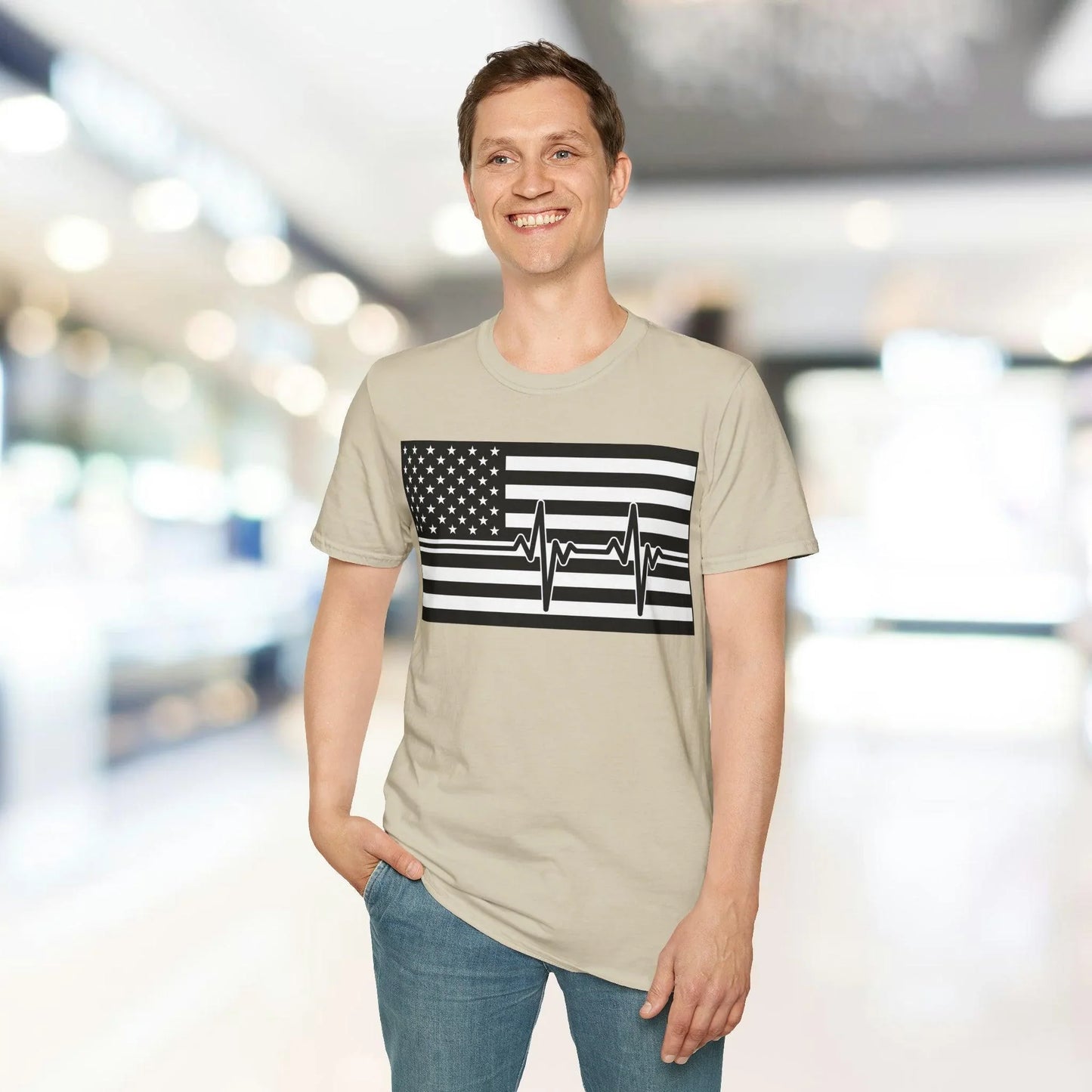 Close-up of the black-and-white American flag heartbeat design on the front chest of the unisex relaxed-fit cotton T-shirt