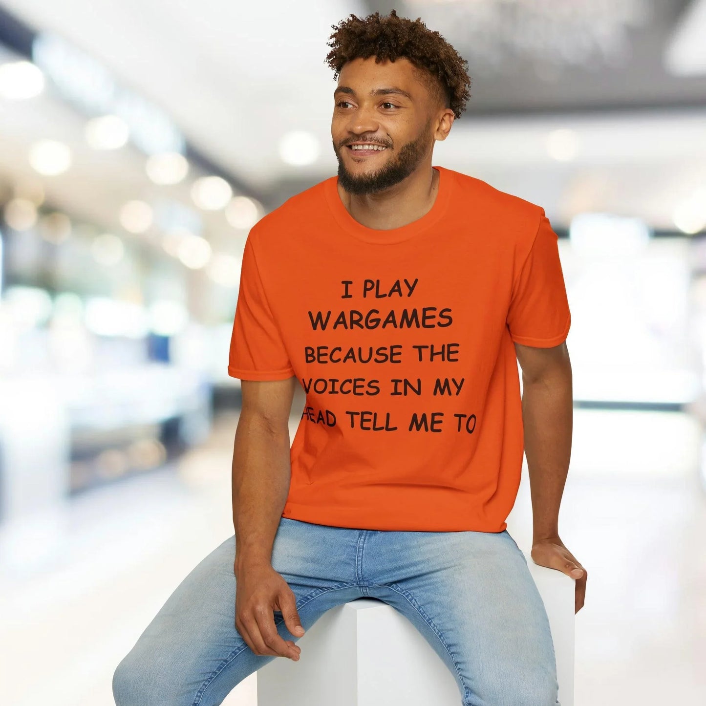 Close-up of black unisex T-shirt fabric displaying subtle texture and fine stitching at the crew neckline from a top-down