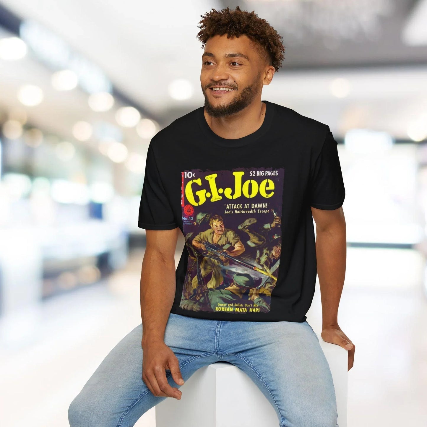 Close-up of the G.I. Joe No.13 unisex softstyle T-shirt label on the hem showing fabric composition and stitching detail