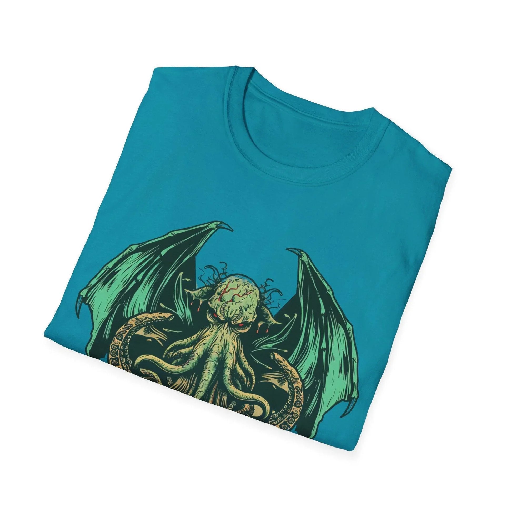 Close-up of navy softstyle cotton fabric and stitched Cthulhu logo at the hemline on the front lower corner of the T-shirt.
