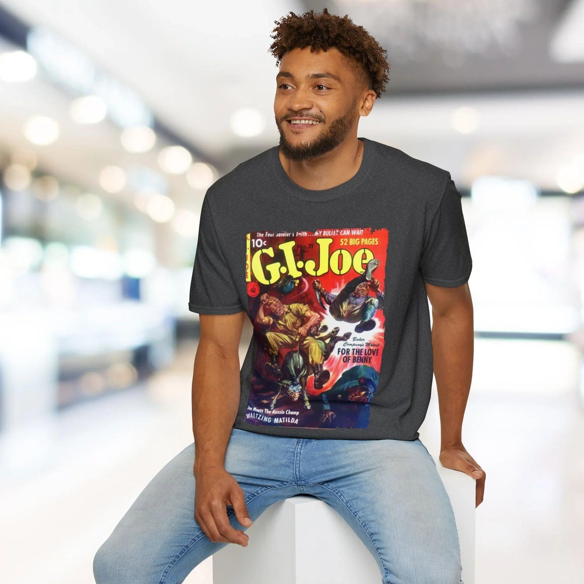 Close-up of the G.I. Joe No.11 softstyle logo tag sewn onto the charcoal gray, relaxed fit cotton T-shirt fabric detail